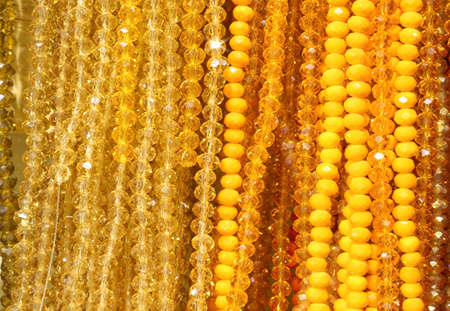 background with orange tint of necklaces for sale in the wholesale jewelery shopの写真素材