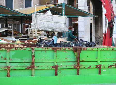 large boat for waste collection in the city of venice in italyの写真素材