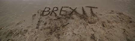 text BREXIT on the sand of the sea waiting to be erased by the wave of the seaの写真素材