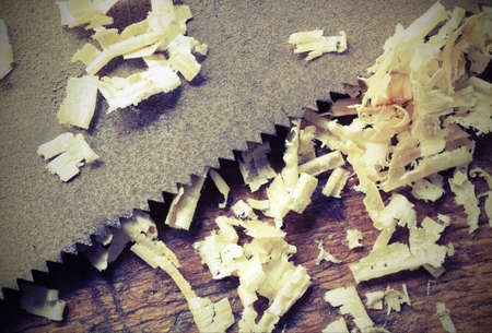 saw and sawdust with macro photography technique and vintage effectの写真素材