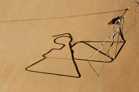 silhouette of an angel and shadow projected on the wallの写真素材