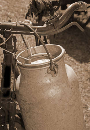 milkman old bicycle with can of milk and ancient sepia effectの写真素材