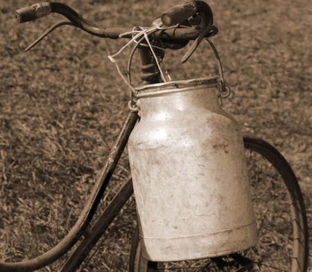 old bicycle milkman with aluminum bin for transporting the milk from the dairy farmの写真素材