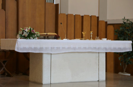Christian church with the altar and the Holy Bible and a vase of flowersの写真素材