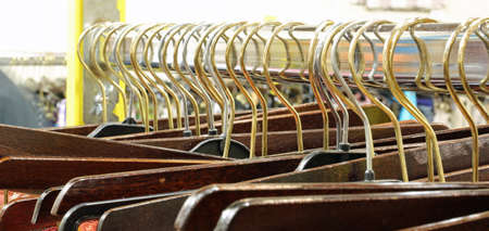 Many hanger hooks with clothes in a clothing storeの写真素材
