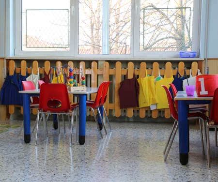 classroom in kindergarten with red small chairs and tablesの写真素材