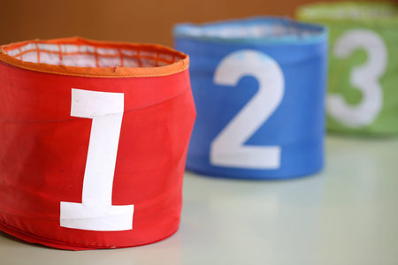 three colorful jars in a school and the red jar with 1 written