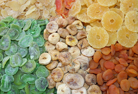 background of many dried fruits with kiwi figs pineapple apricots