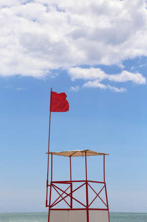 Lifeguard tower with red flag in tropical resort beachの写真素材