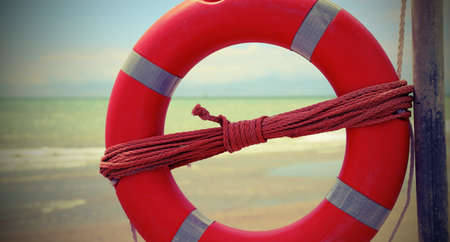 Vintage effect with orange life-buoy on the tropical beachの写真素材