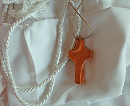 white tunic with wooden cross for religious rite