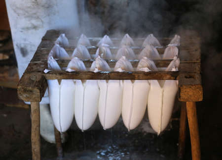 cheese making in a small dairy inside the mountain pastureの写真素材