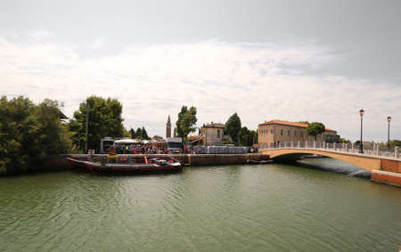 wide view of a waterway and bridge with the local market in background of the small town of Treporti near Venice in northern Italyの写真素材