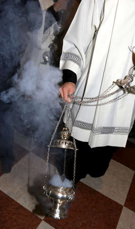Christian priest blessing with incense in the church during Holy Massの写真素材