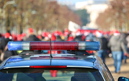 blue and red sirens on the police car  during the manifestation in the public parkの写真素材