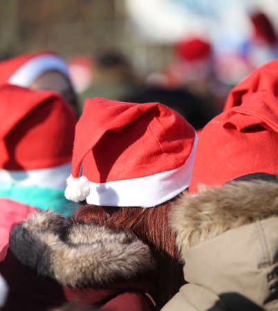 many young people with red hat of Santa Claus at holidaysの写真素材