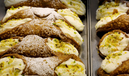 many Sicilian cannoli stuffed with ricotta cheese and pistachios