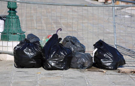 abandoned black garbage bags in a city
