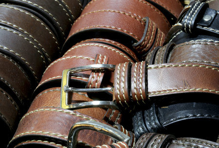 many leather belts for sale in the Italian artisan workshop