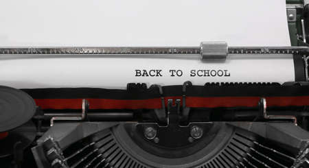 Text BACK TO SCHOOL on the old typewriter on white sheetの写真素材