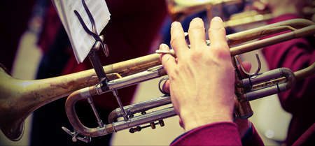 trumpeter plays his trumpet in the brass band during live concert with vintage effectの写真素材