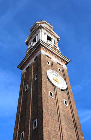 High bell tower of the Church of SANTI APOSTOLI in Venice Italyの写真素材