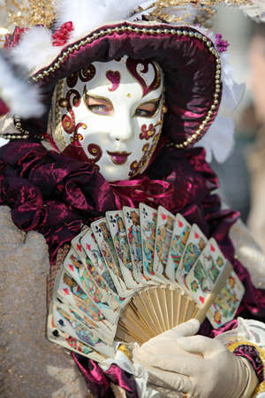 Venice, Italy - February 5, 2018: person in costume with Handmade carnival costume with a large fan in handのeditorial素材