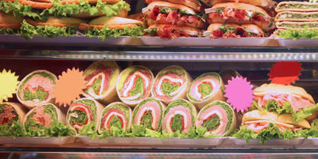 great and inviting window full of sandwiches and snacks in the well stocked barの写真素材