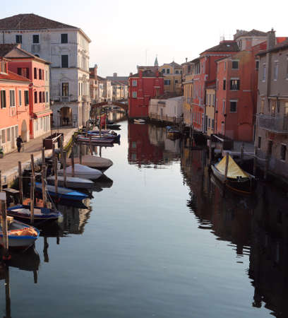 Wide canal with boats in Chioggia Island near Venice in Italyの写真素材