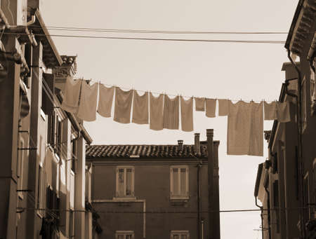 many hanging clothes out of house of an european cityの写真素材