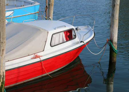 red and white small boat mooredの写真素材
