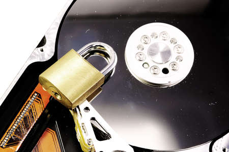 hard disk drive of a computer with a closed padlock as a concept for computer data security on a white backgroundの写真素材