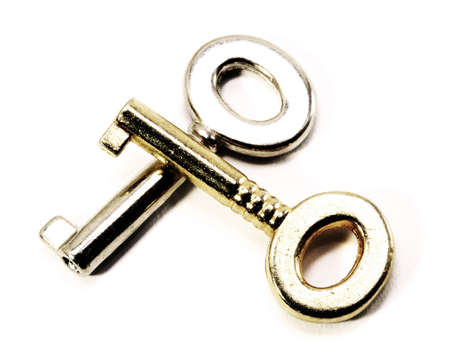 two metallic keys of gold and silver with a very light effectの写真素材
