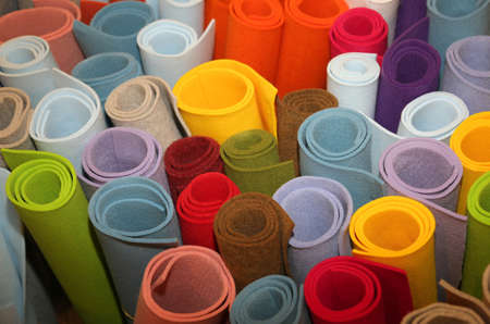 many colored rolls of fabric in the storeの写真素材