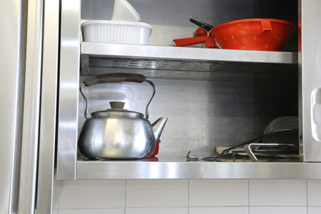 metal teapot in the sideboard of a school canteen