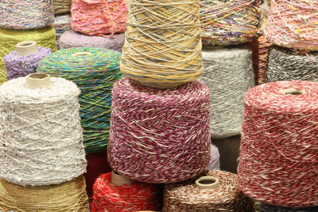coils and spools of fine colored wool thread for the creation of handmade sweaters