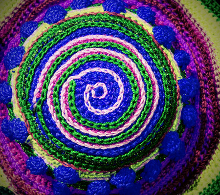 colored spiral with woven threads in the shape of a circle