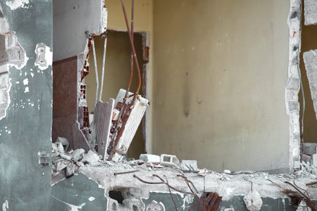 big hole on the wall of the destroyed house during the bombings