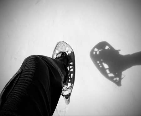 white snow and a snowshoe with shadow in mountain with black and white effectの写真素材