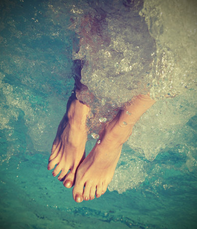 woman during the whirlpool therapy in the spa pool with vintage effect