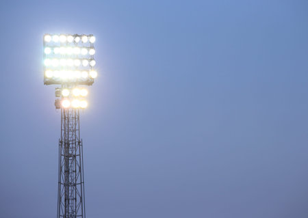 one-stage spotlights lit for a football game played at nightの写真素材