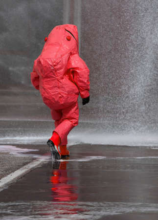 fireman with red protective gear against biological riskの写真素材