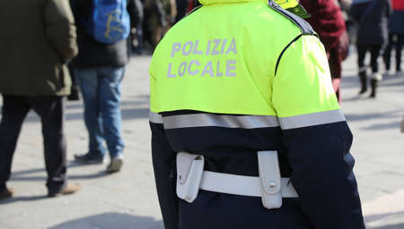 Policeman with uniform and the text POLIZIA LOCALE that meas Local Police in Italian languageの素材 [FY310103112048]