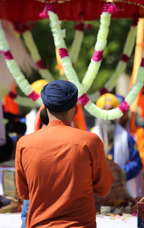 Young sikh man with small blue turban
