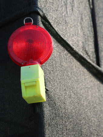 big Red signal lamp of a road construction site with protective net