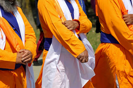 Sikh soldiers with orange and white traditional dress participate in a religious eventの写真素材