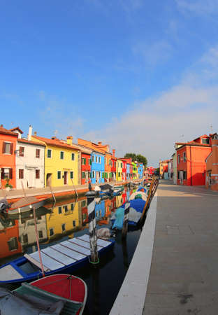 Vivid colors of the houses in Burano  near Venice in Italy and with navigable water wayの写真素材