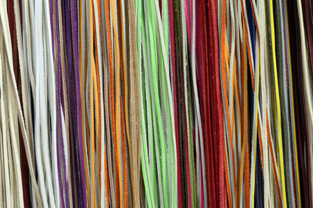 background of long threads of different colors hanging