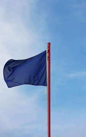 blue flag is symbol of not pollution in this area in vertical modeの写真素材