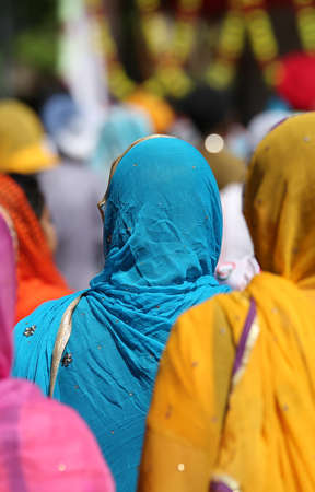 sikh young woman with colourful clothes during a religious ceremonyの写真素材